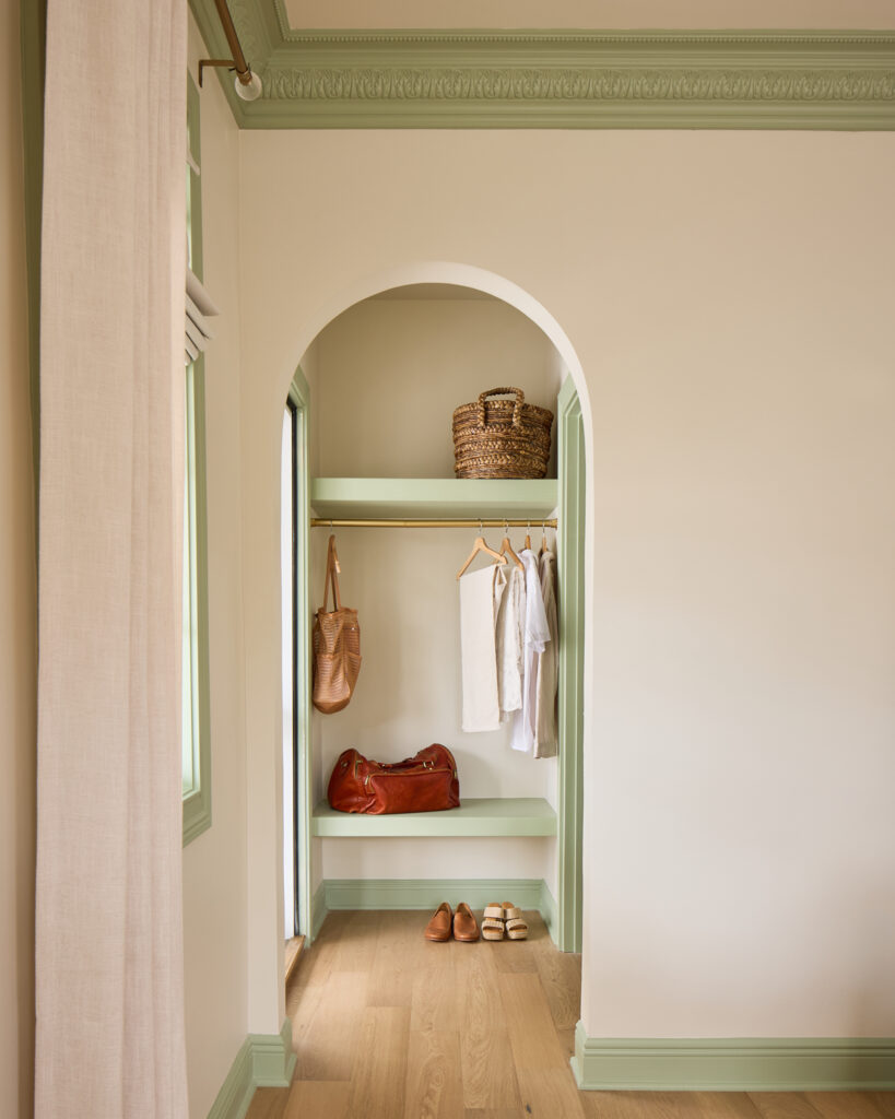 Arched sage green built-in closet with open shelving in a Spring Sanctuary bedroom