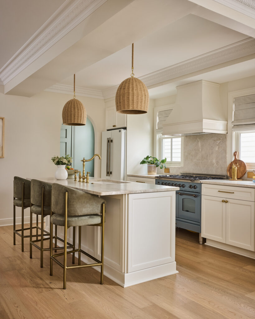 Kitchen with rattan pendants, counter stools and island at Spring Sanctuary